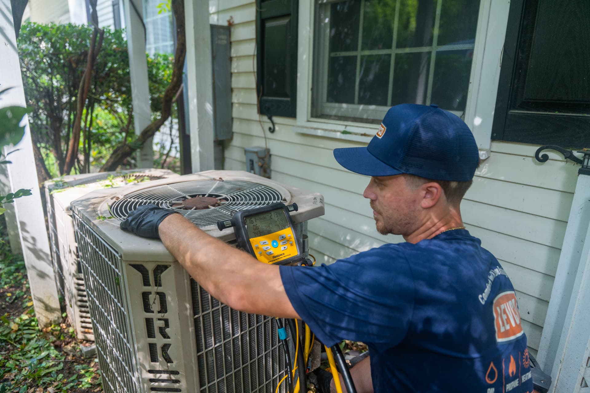 Levco technician checking a central air conditioner after a no-cooling call