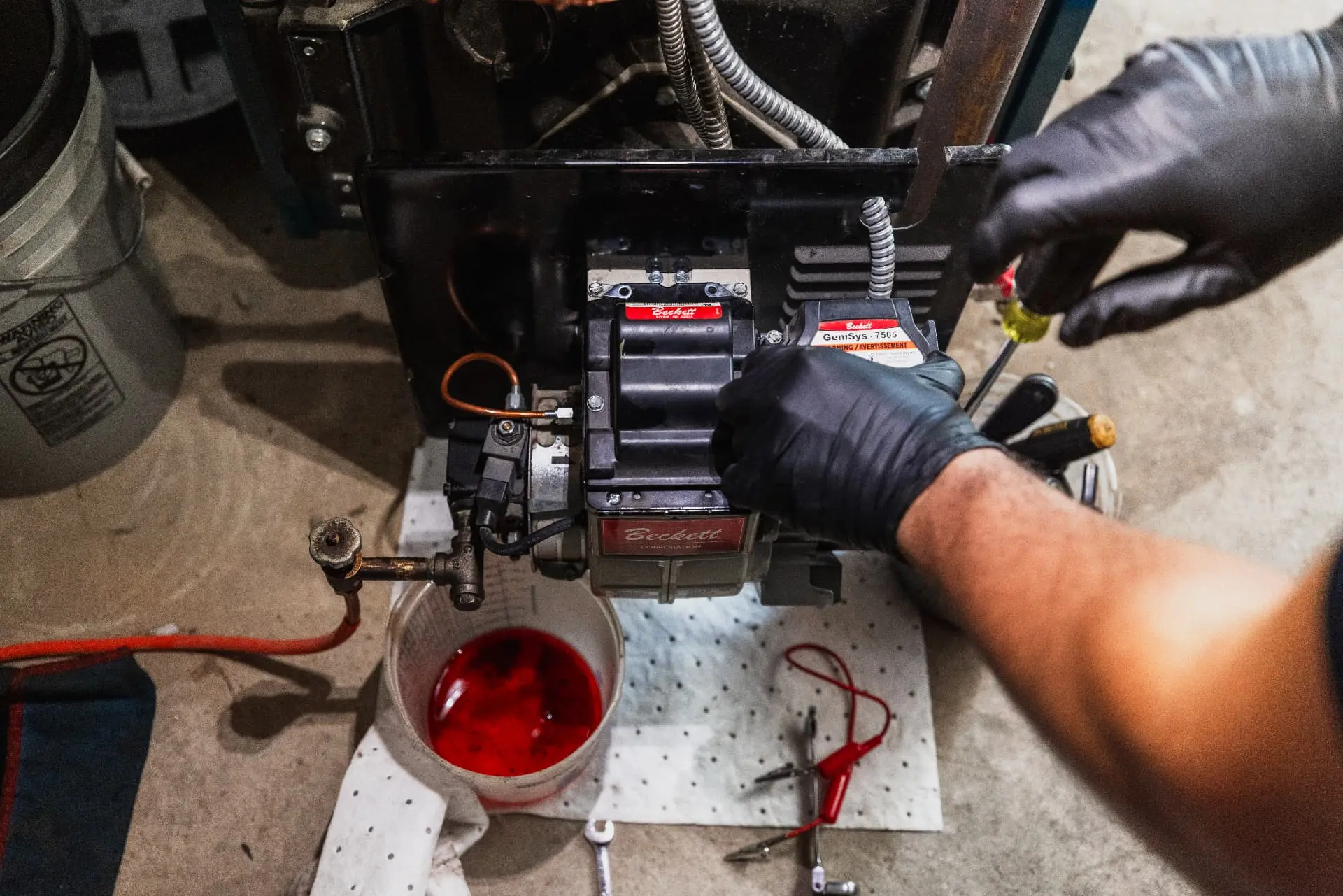 Levco technician making a careful burner adjustment during preventative maintenance