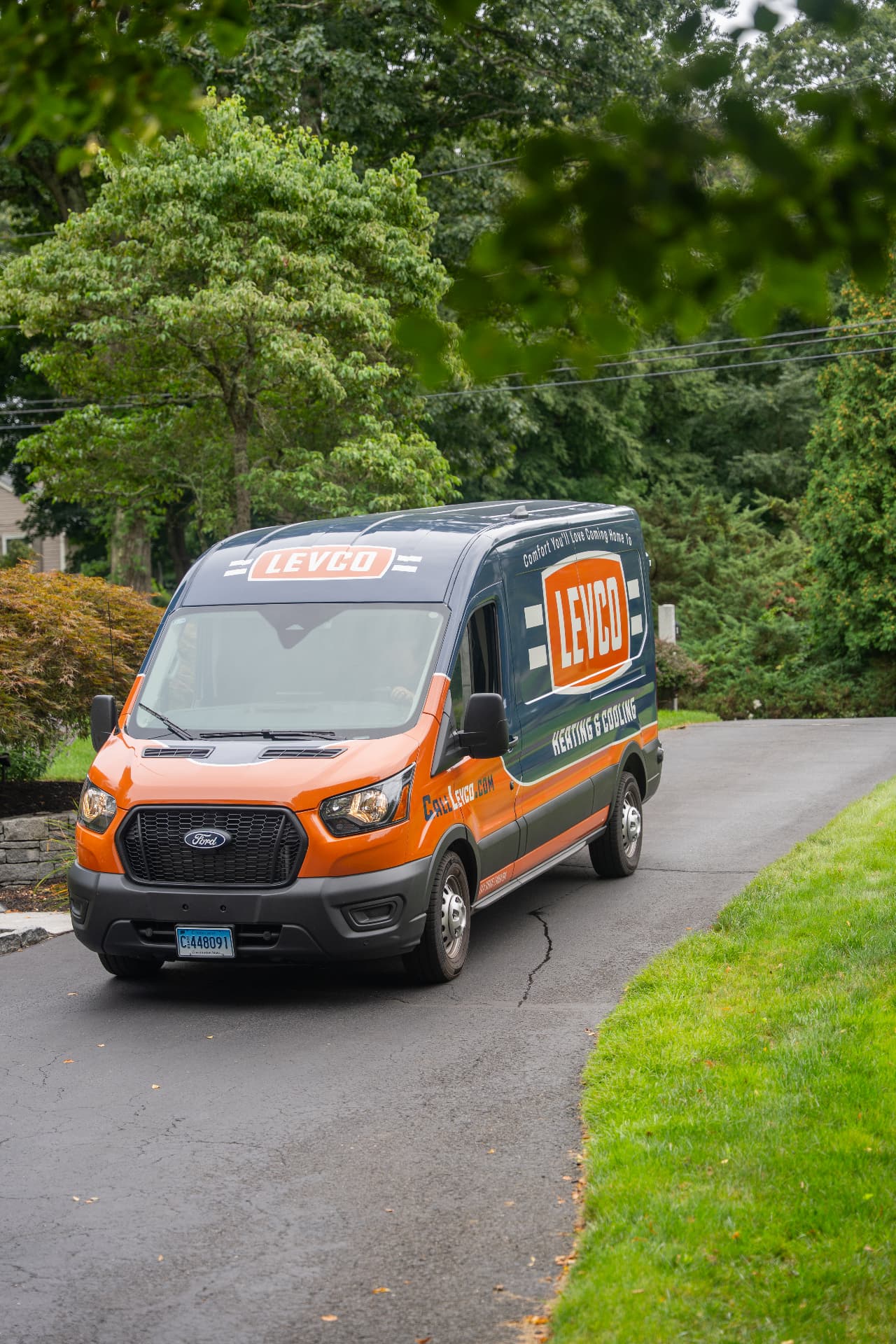 Levco service van arriving in a Connecticut homeowner's driveway