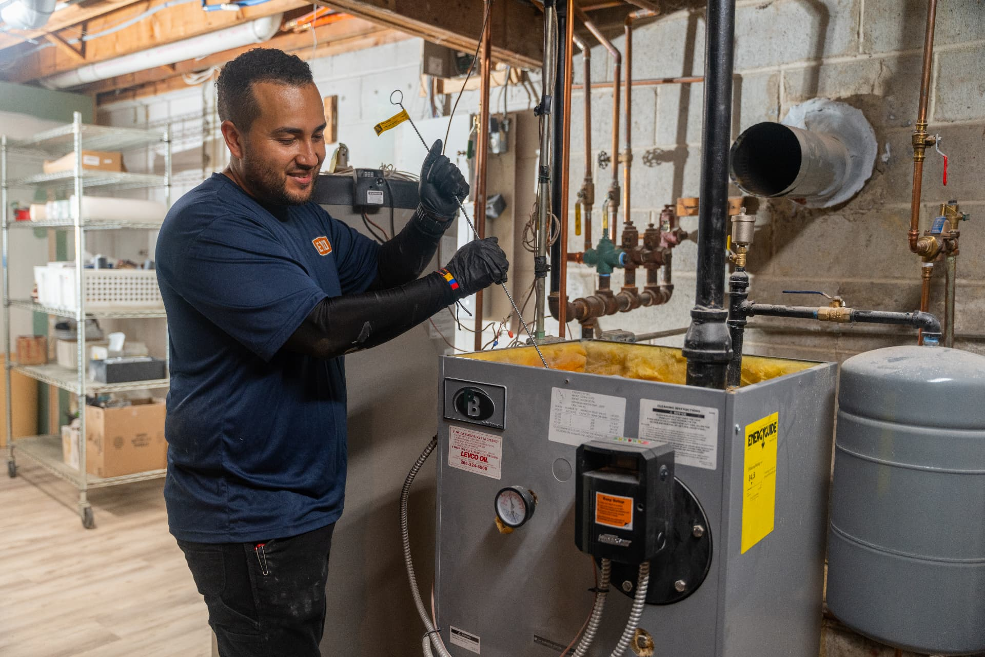 Levco technician inspecting a boiler during preventative heating maintenance