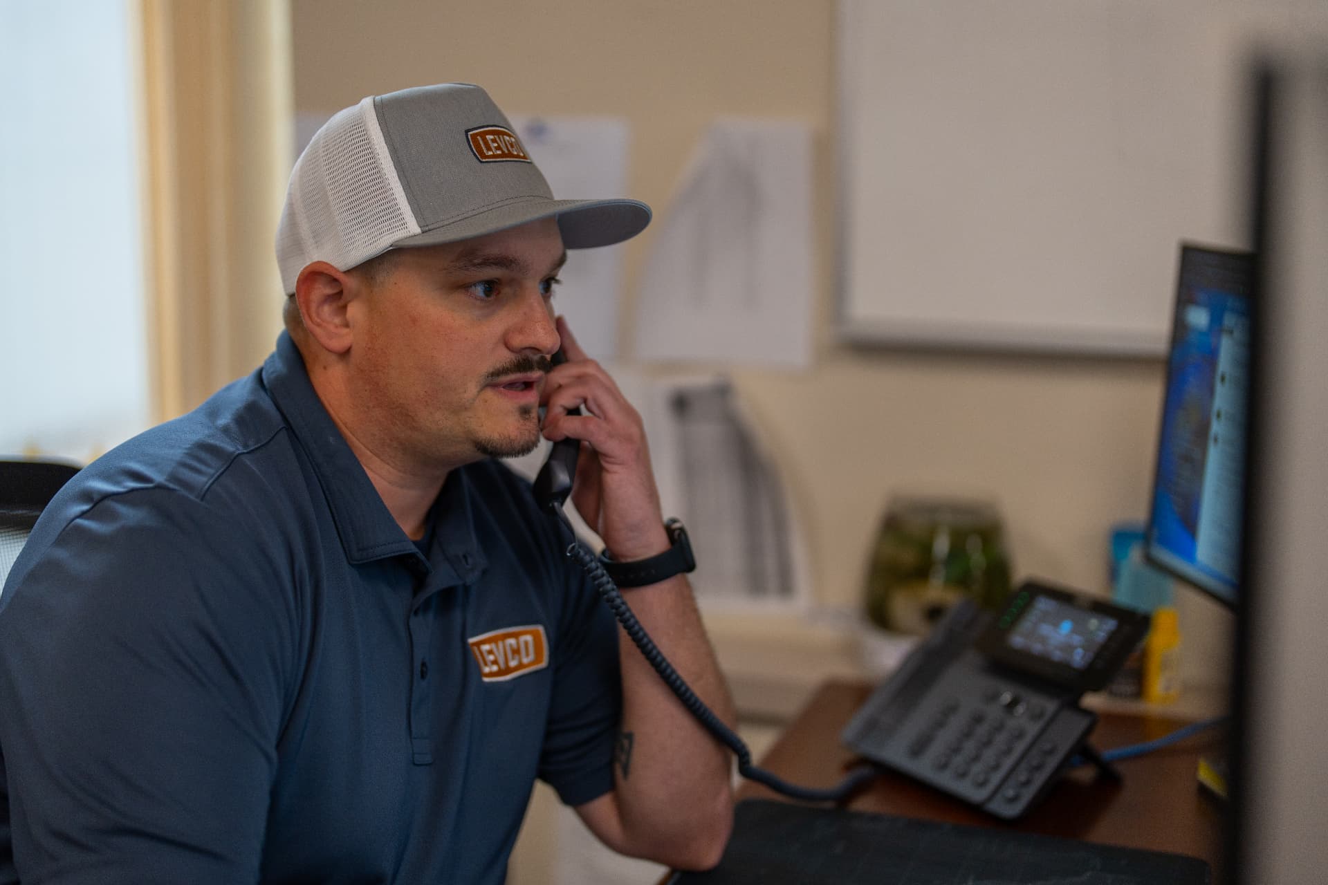 Levco team member helping a customer by phone from the Trumbull office