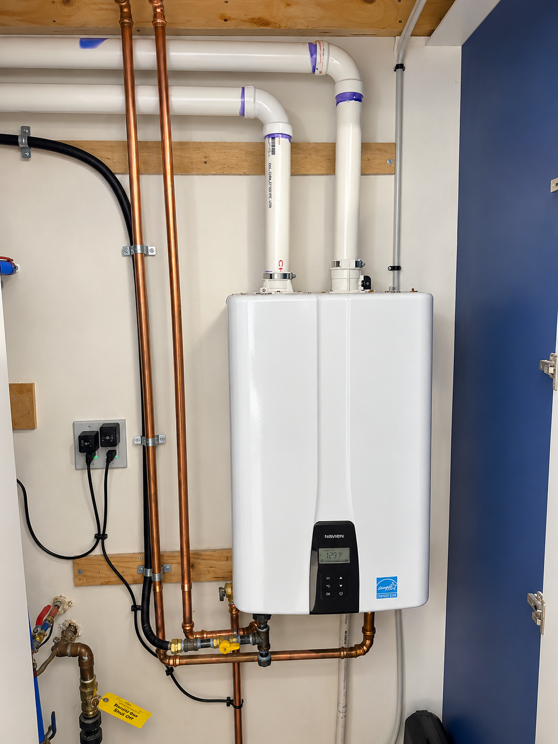 High-efficiency Navien wall-mounted heating system with finished copper piping