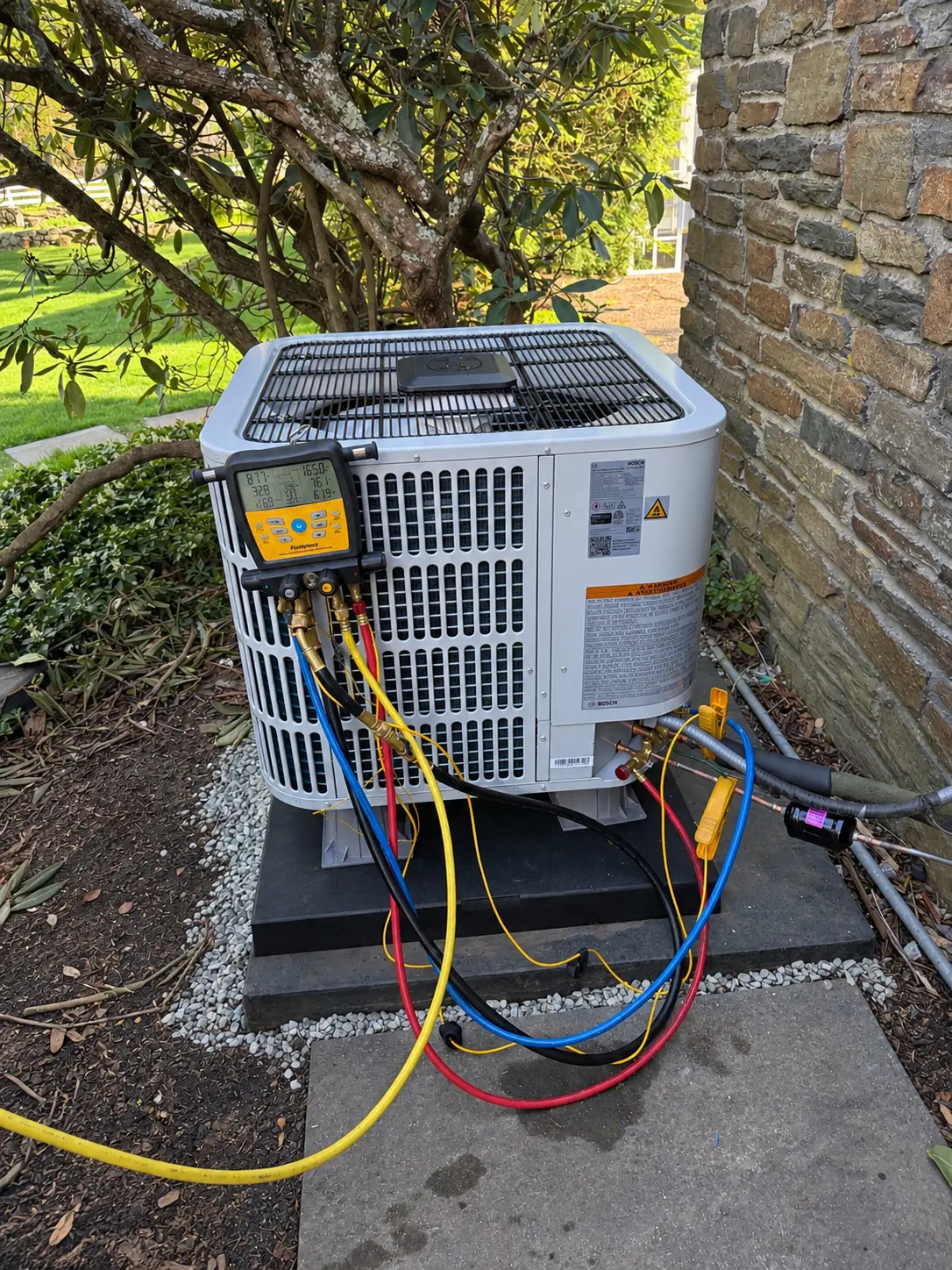 Diagnostic gauges connected to a Bosch heat pump during system testing