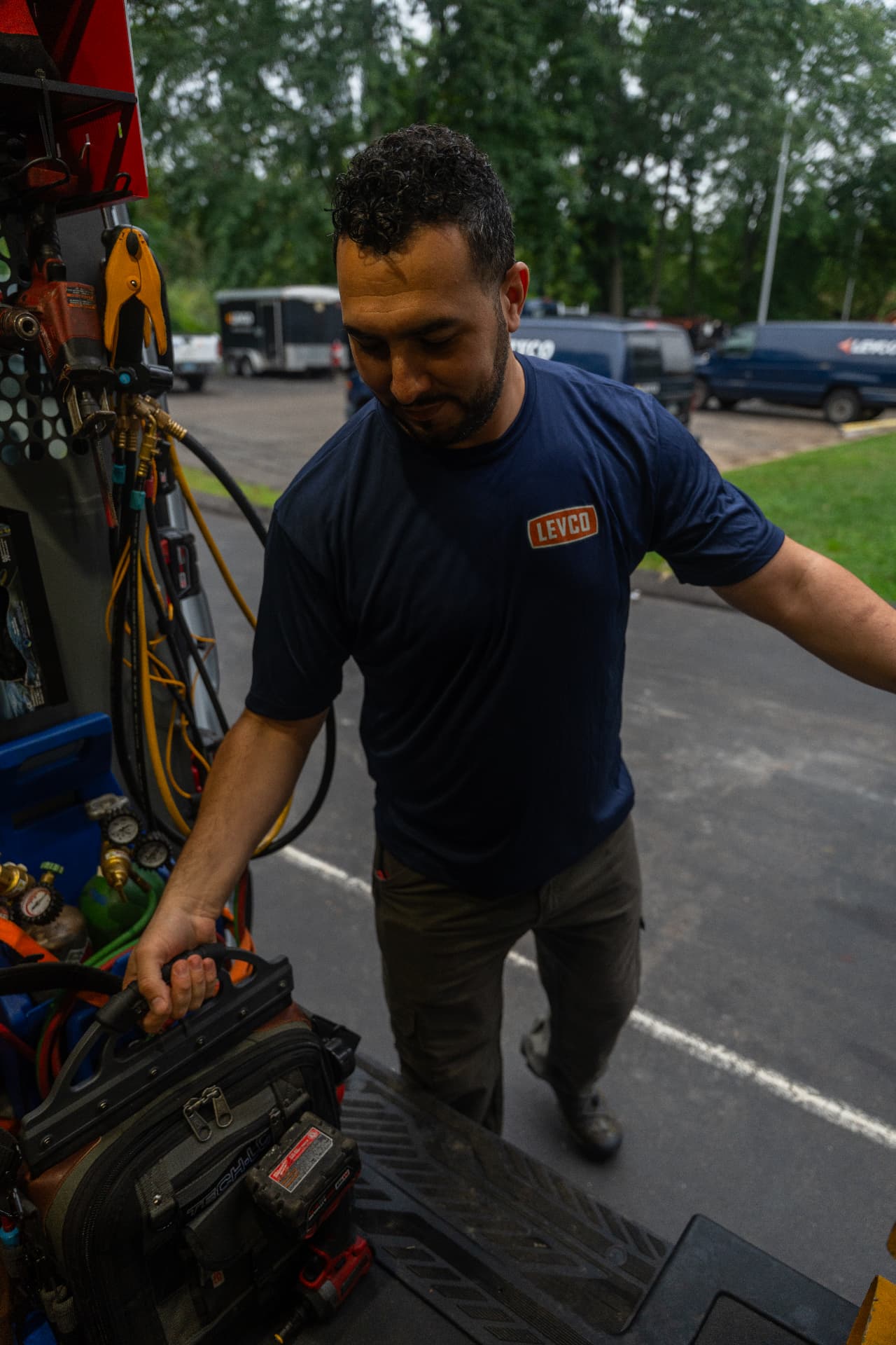 Levco heating technician loading service tools from a fully stocked Levco truck