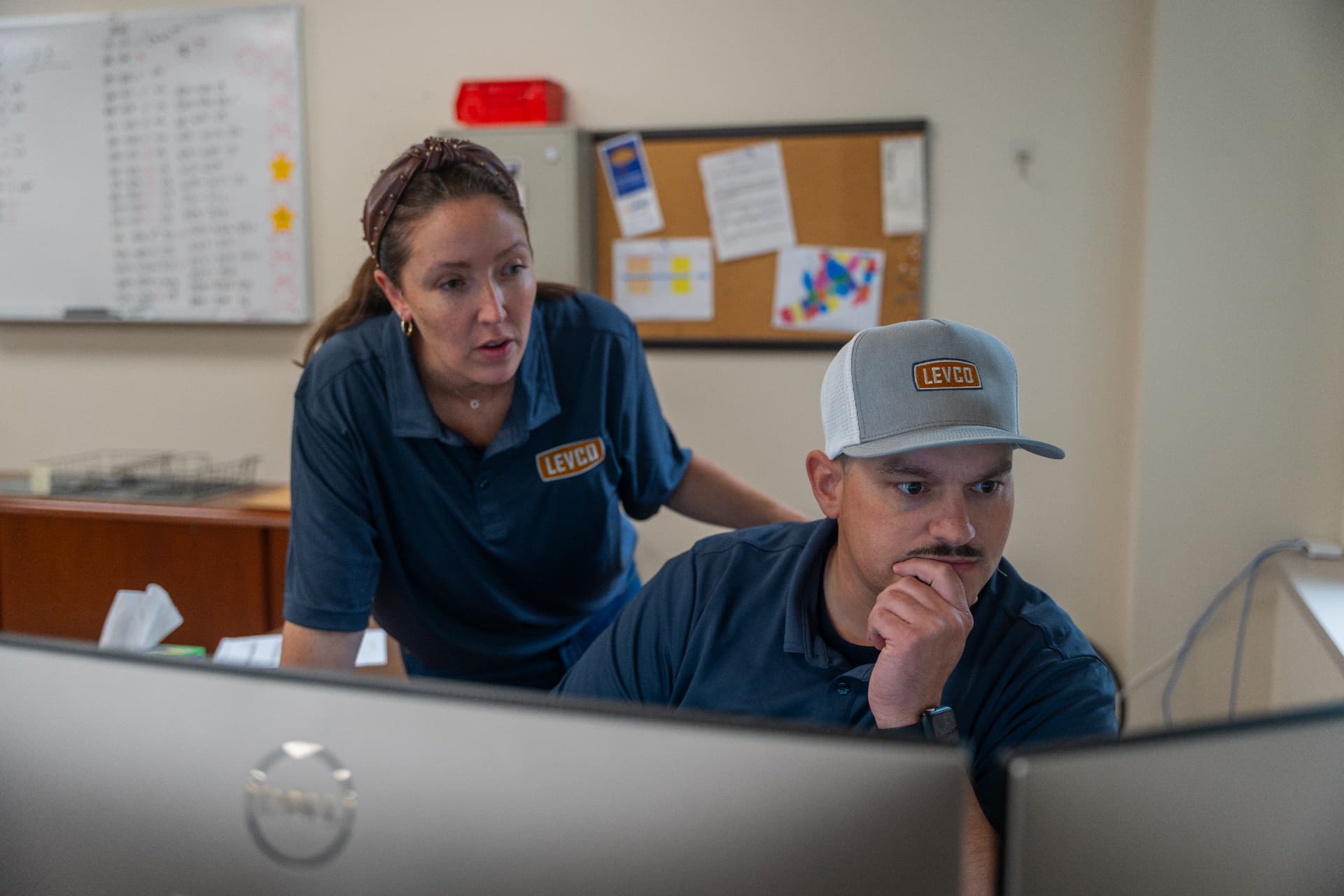 Levco dispatchers reviewing the day's schedule together at the office