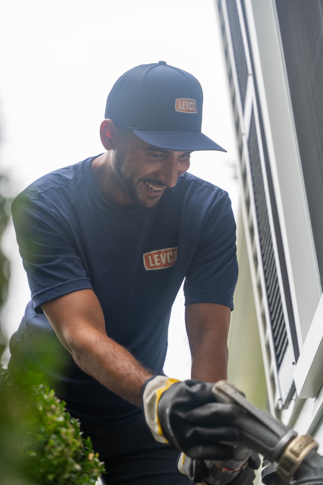 Smiling Levco delivery driver making a heating oil delivery at a home