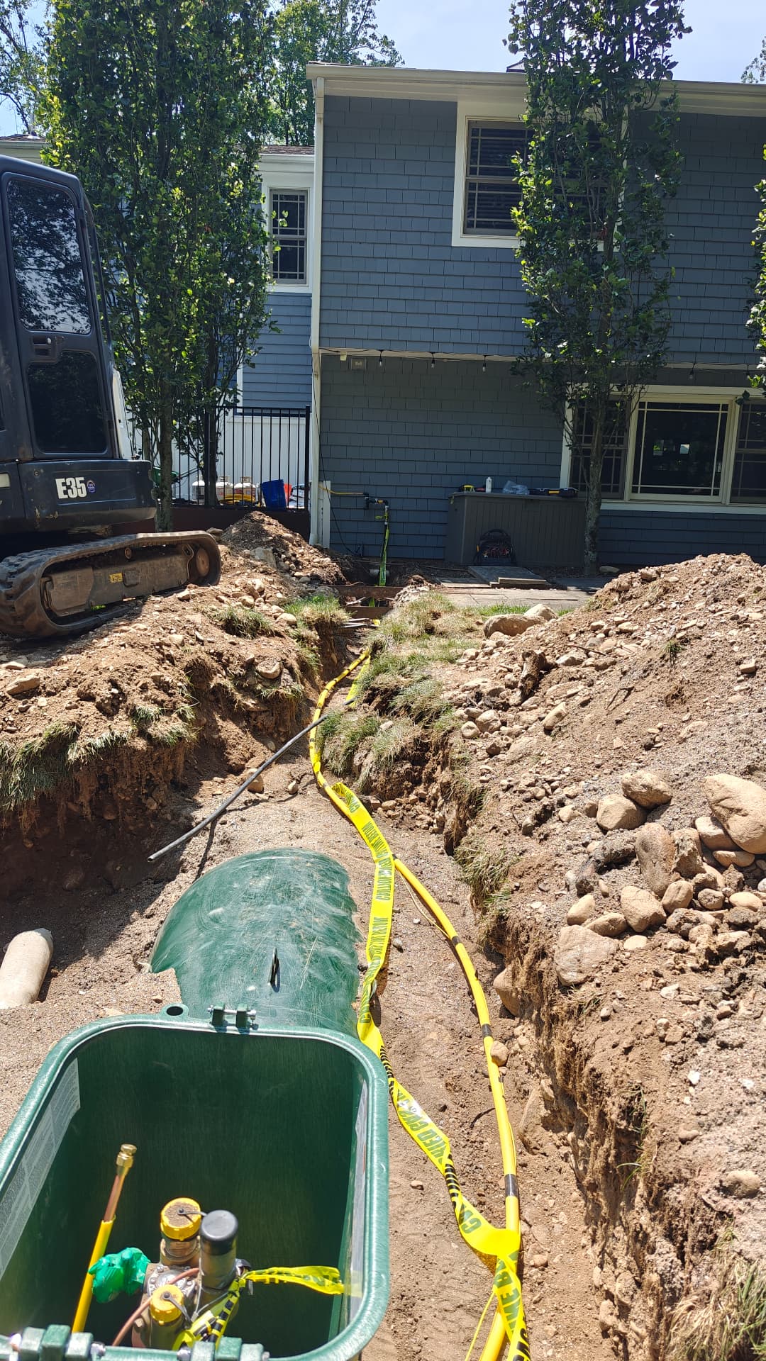 Underground propane tank being installed beside a Connecticut home