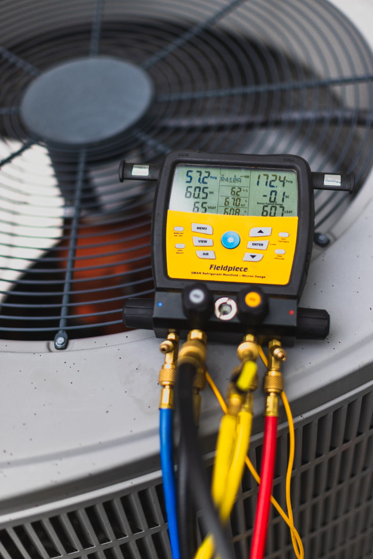 Refrigerant diagnostic gauges connected to a residential air conditioner