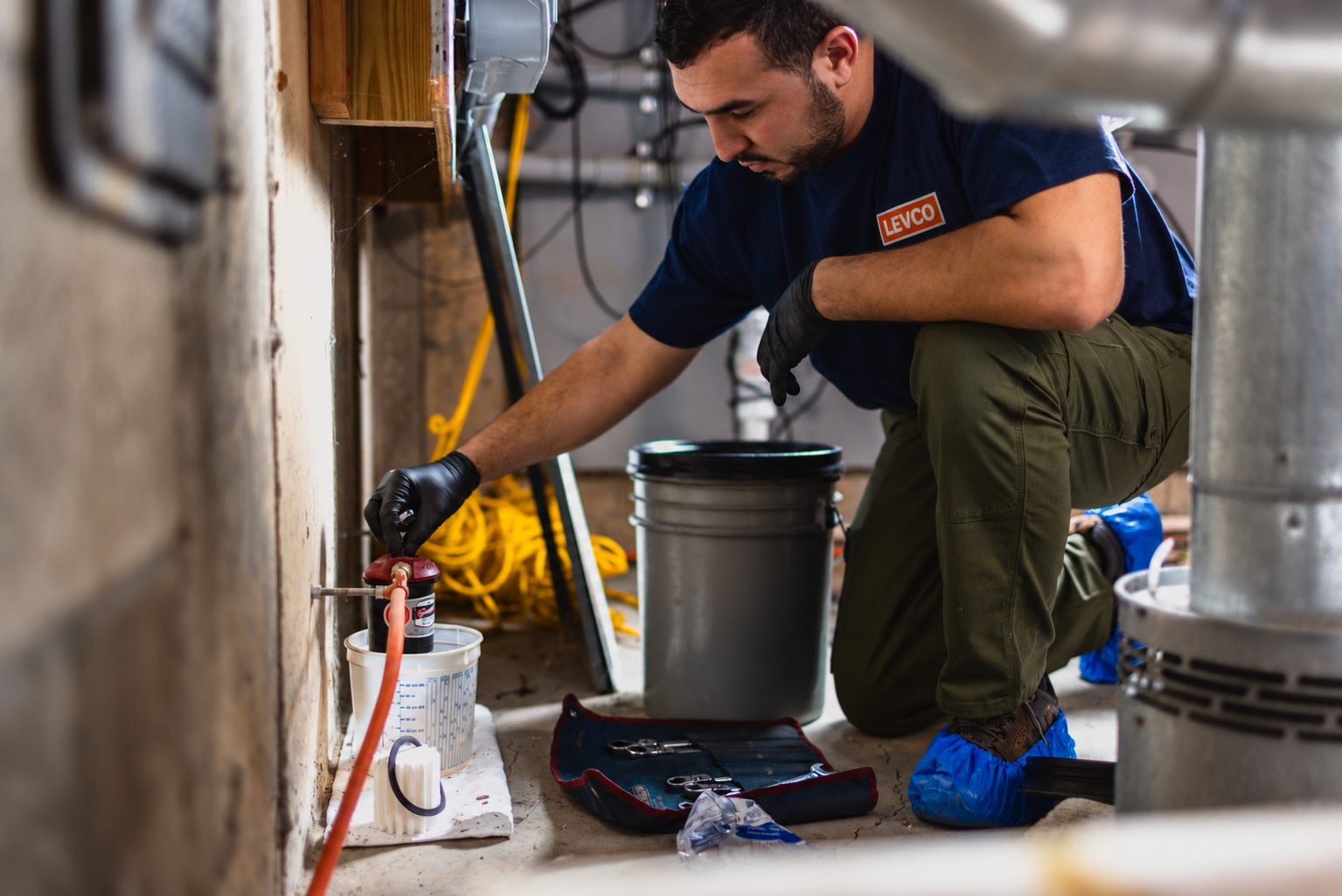Levco technician servicing an oil filter during preventative heating maintenance