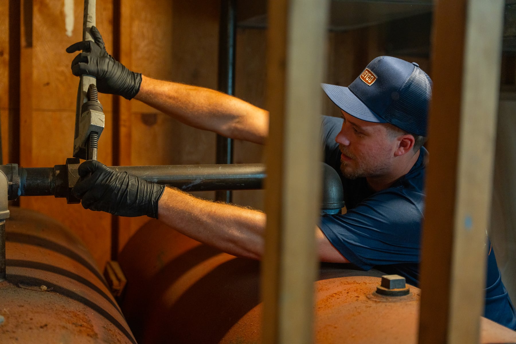 Levco technician servicing the piping on an indoor heating oil tank